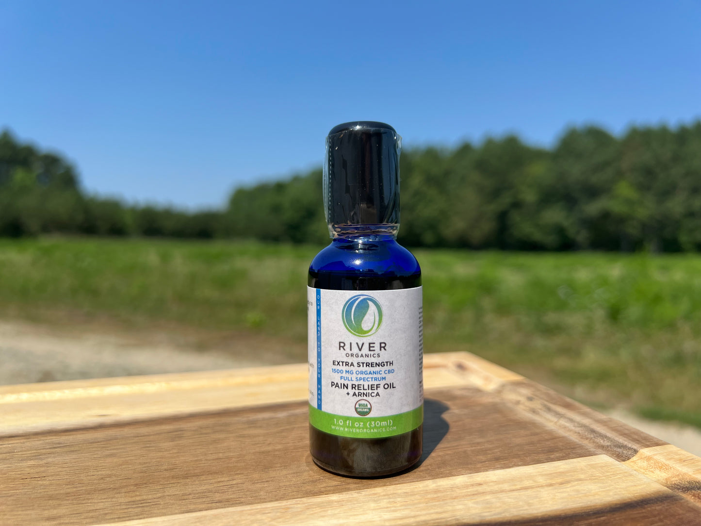 arnica cbd oil on wooden plank on farm