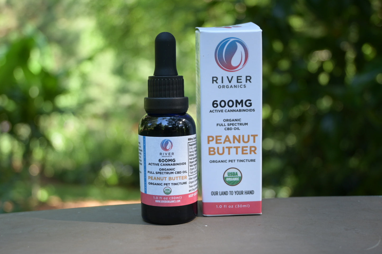 600mg peanut butter pet tincture with box in garden
