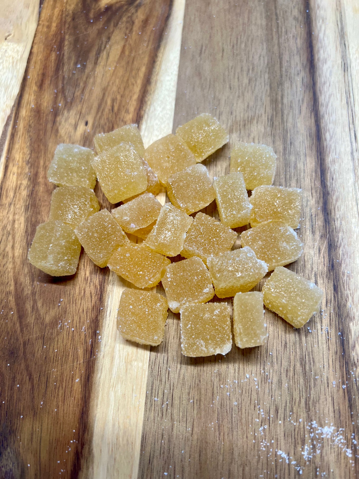Pineapple Mango cbd gummies on wooden plank