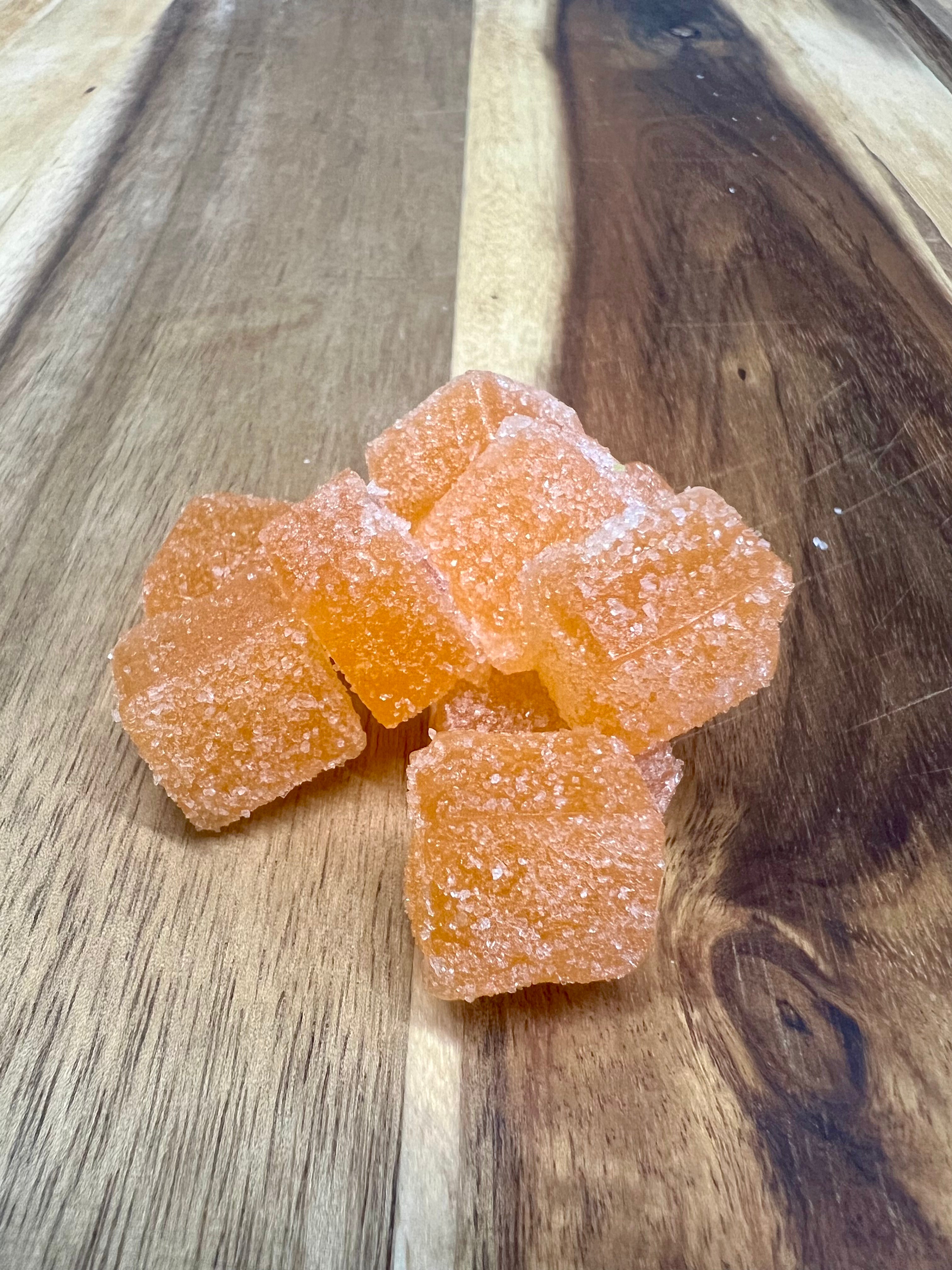 Peach cbd gummies on wooden plank